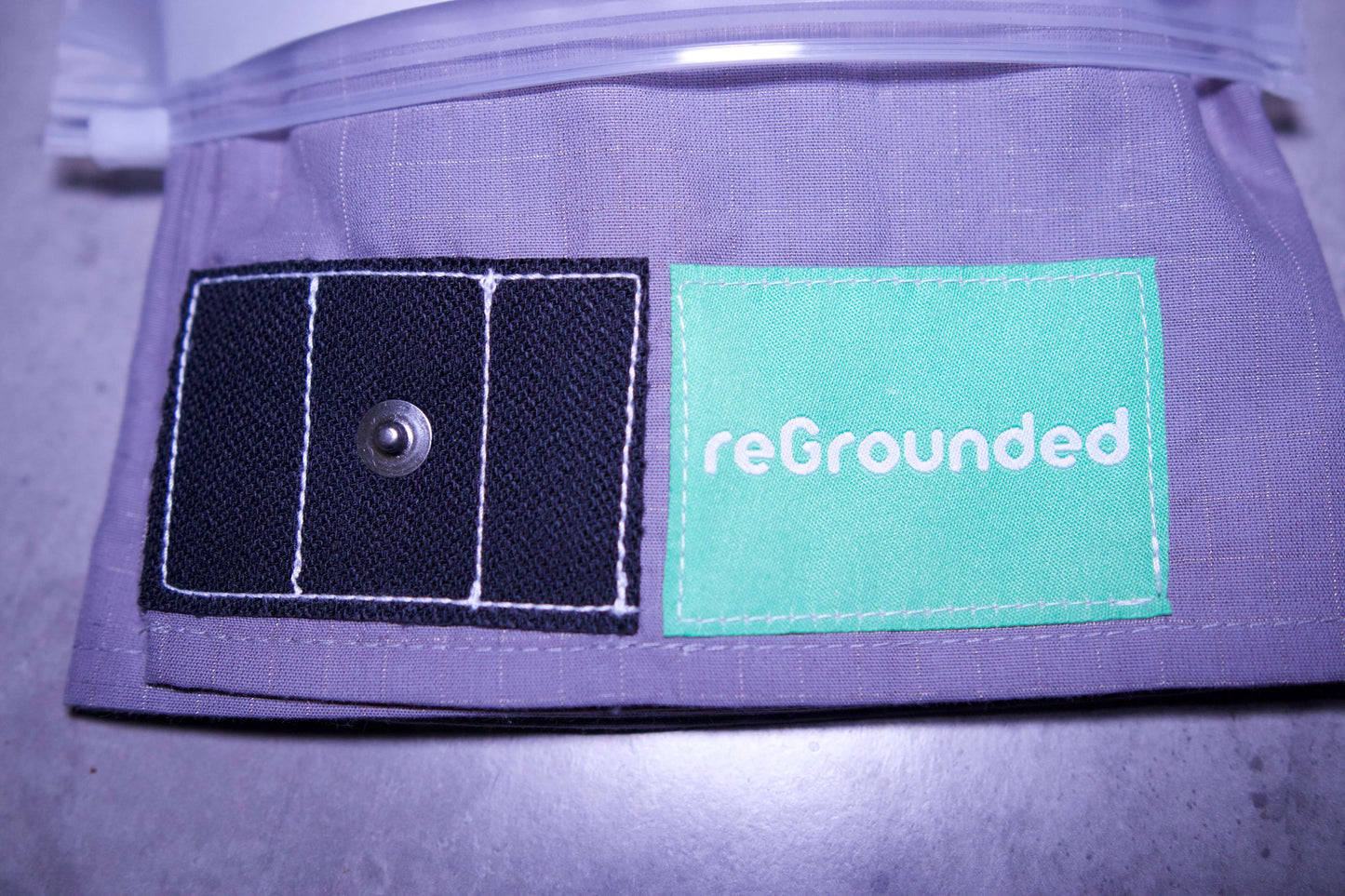 Grounding pillowcase showing reGrounded label and snap connection point for grounding cord.