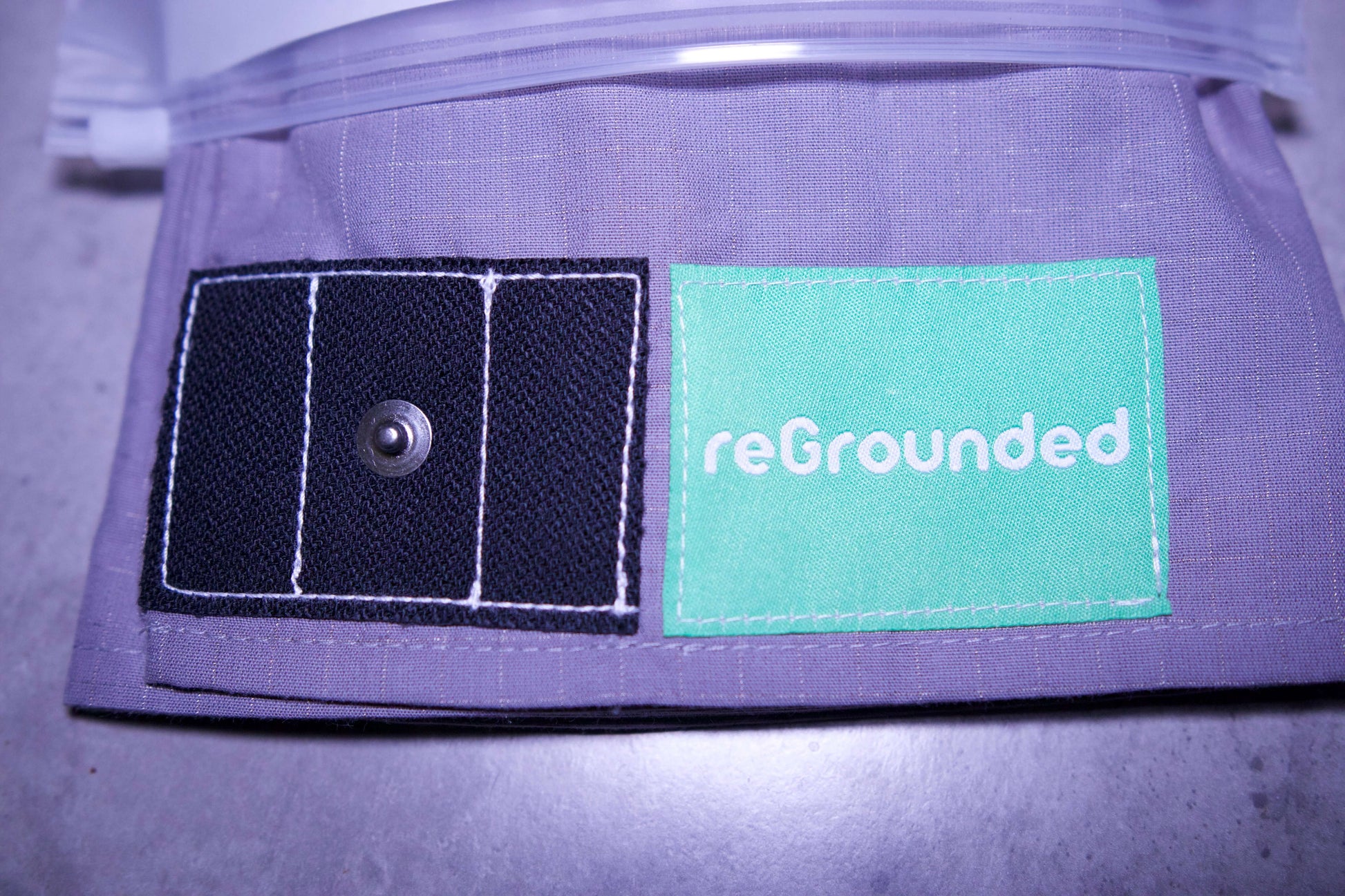Grounding pillowcase showing reGrounded label and snap connection point for grounding cord.