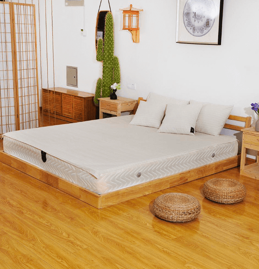 Grounding flat sheet on beige bed in a minimalist, Zen-inspired bedroom with natural lighting.
