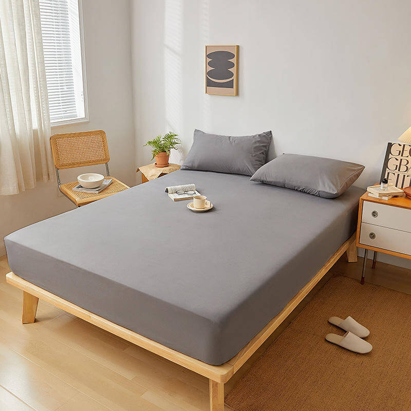 Fitted grounding bed sheet displayed on wooden bed in modern bedroom setting.