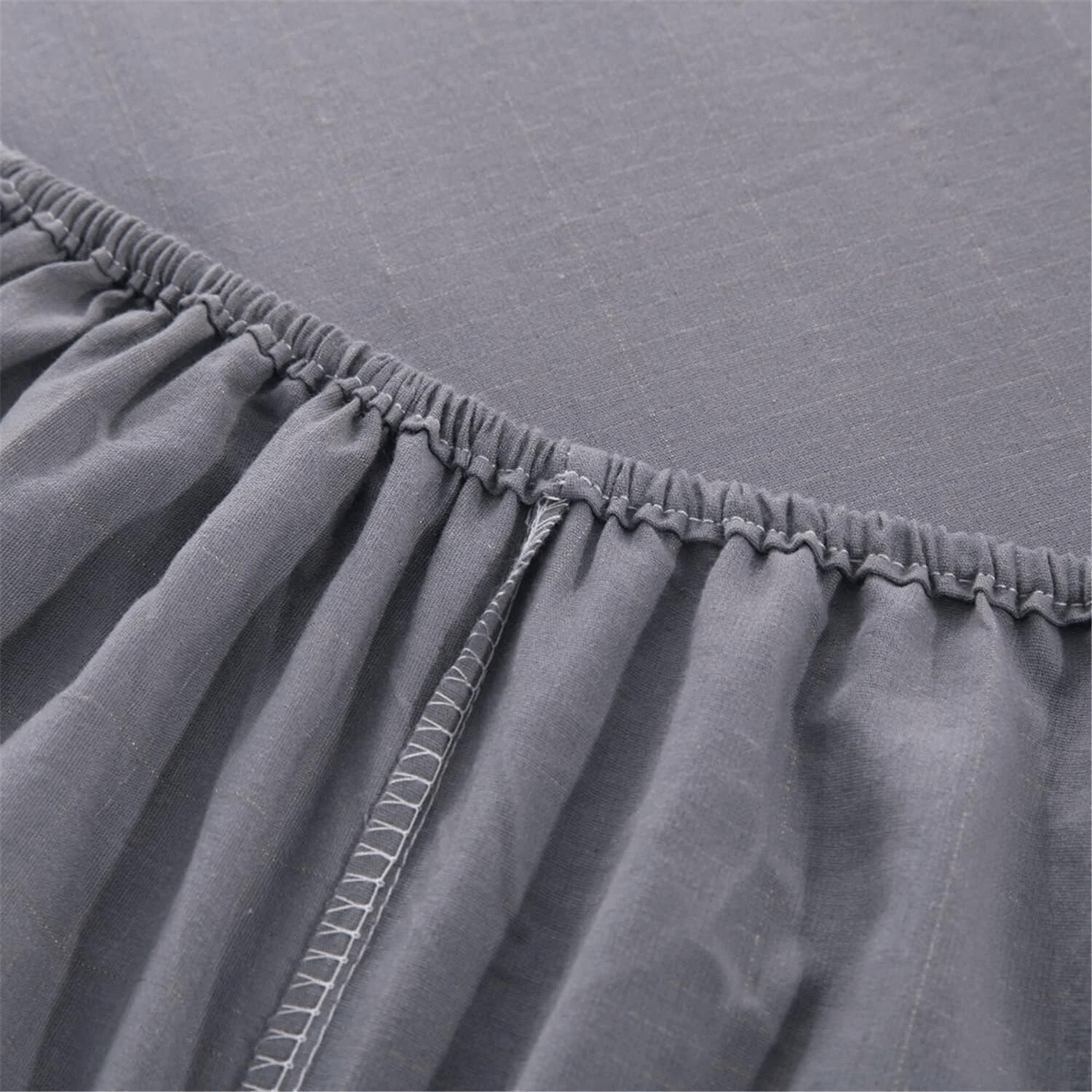 Close-up of elasticated corner of fitted grounding bed sheet showing quality stitching.