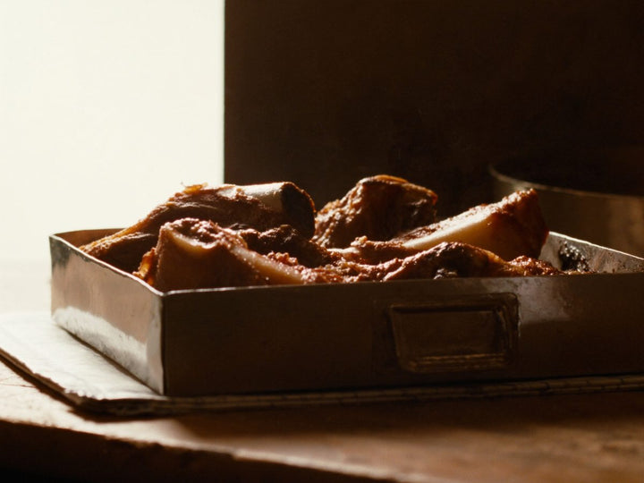 Roasted beef marrow and knuckle bones in a roasting tin