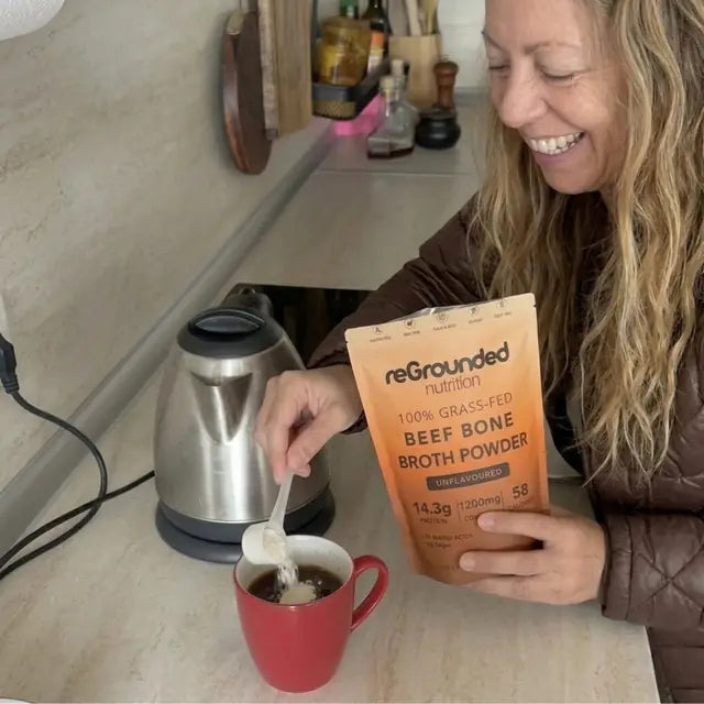 reGrounded customer stirring beef bone broth powder into her morning mug