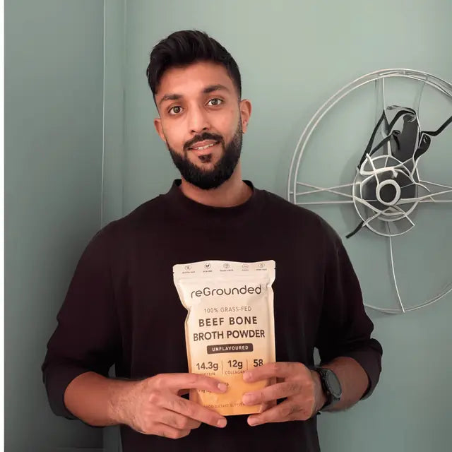 reGrounded customer holding his beef bone broth pouch